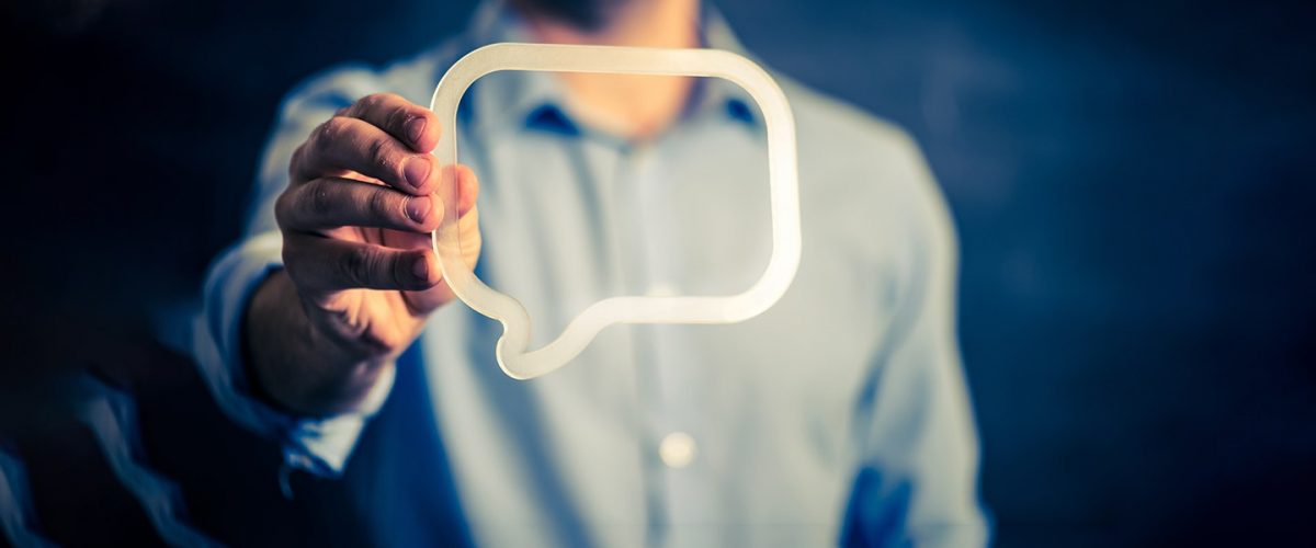 Man holding a speech bubble.