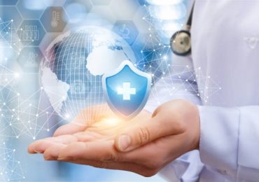 Doctor holding a technology globe - medical device security.